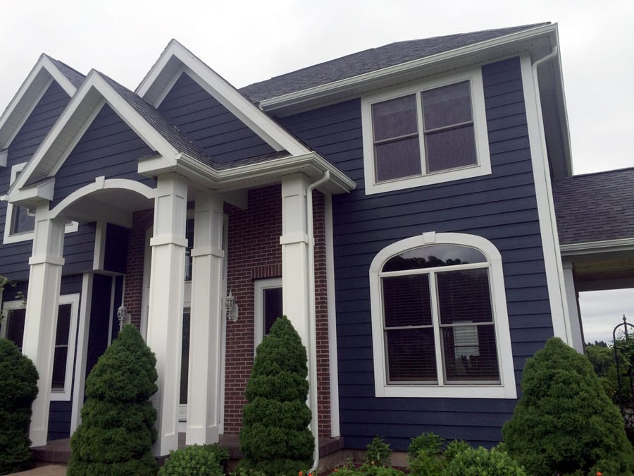 Modern home with new roofing and white eavestrough installation
